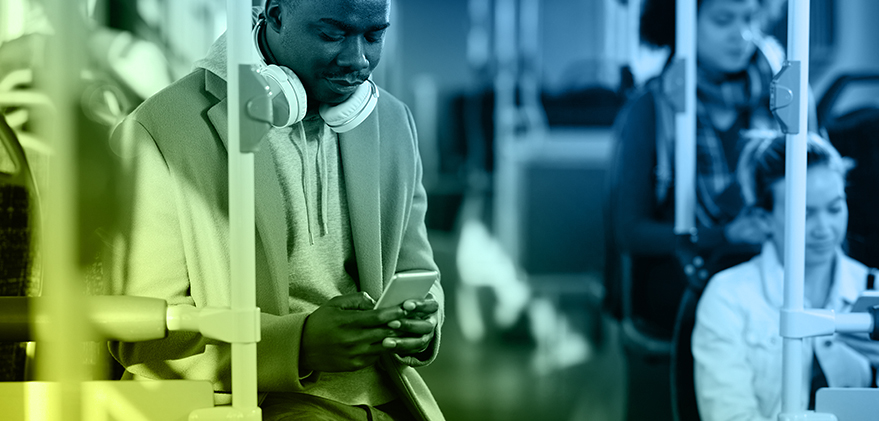 man on bus looking at his phone - transportation partners